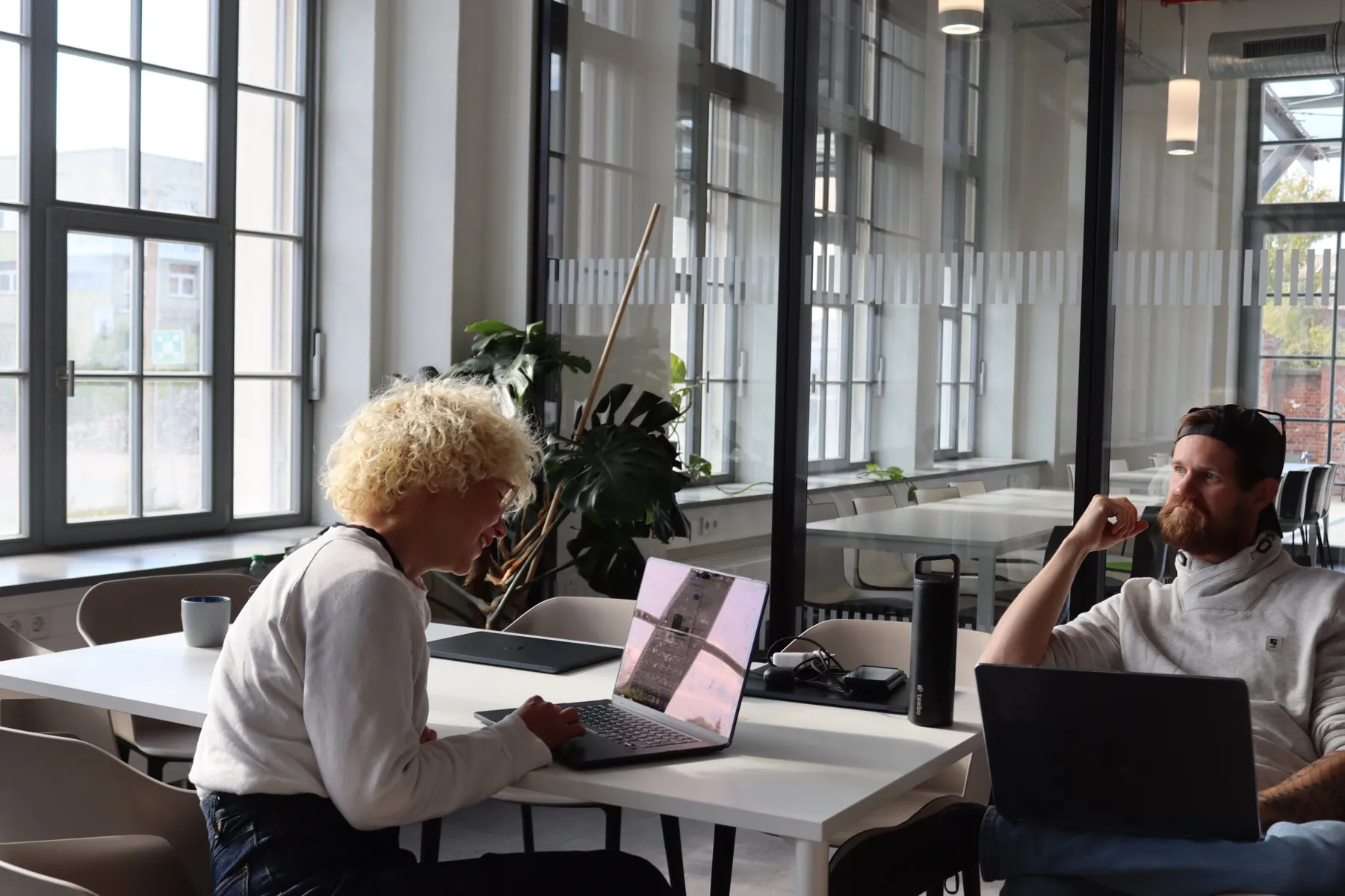 Two colleagues working at a laptop in the Leipzig office
