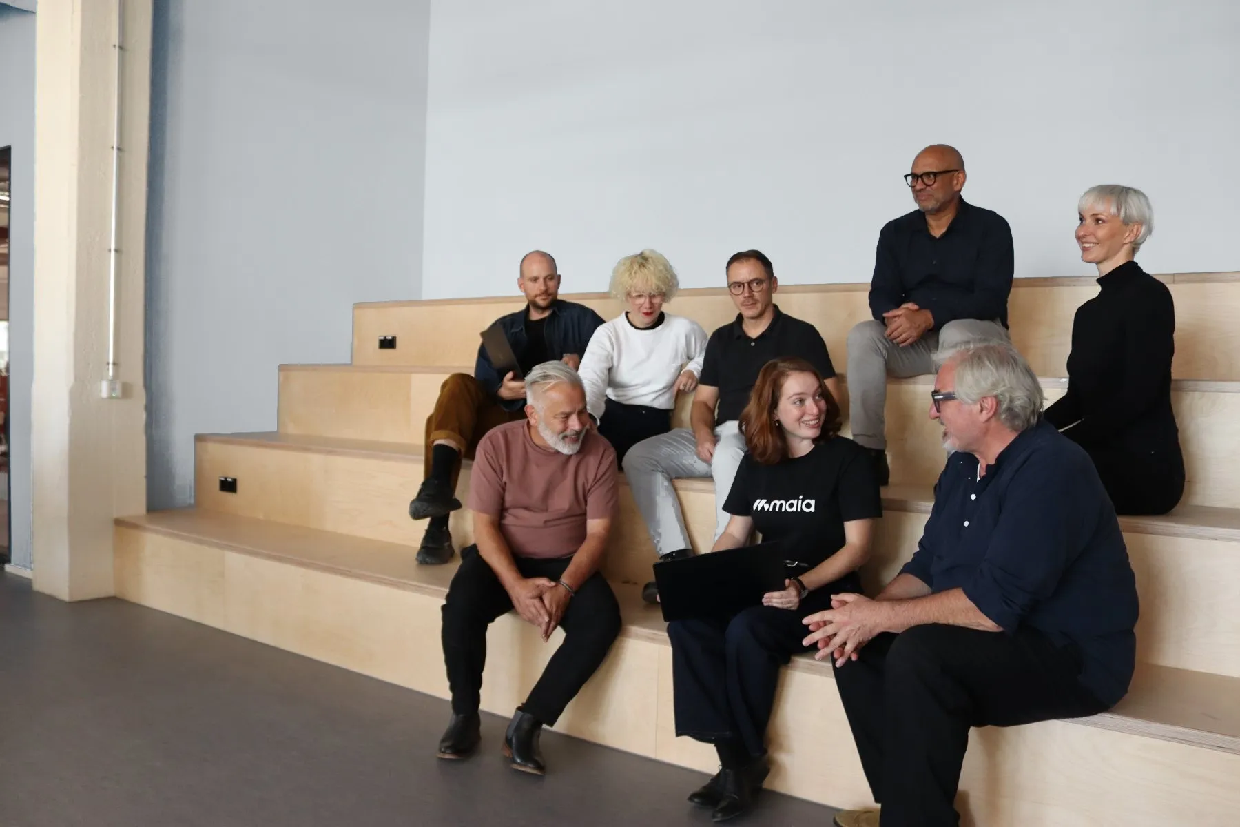 The MAIA team talking on the seating steps